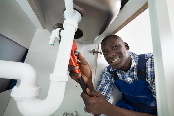 PlombGH technician repairing a sink pipe